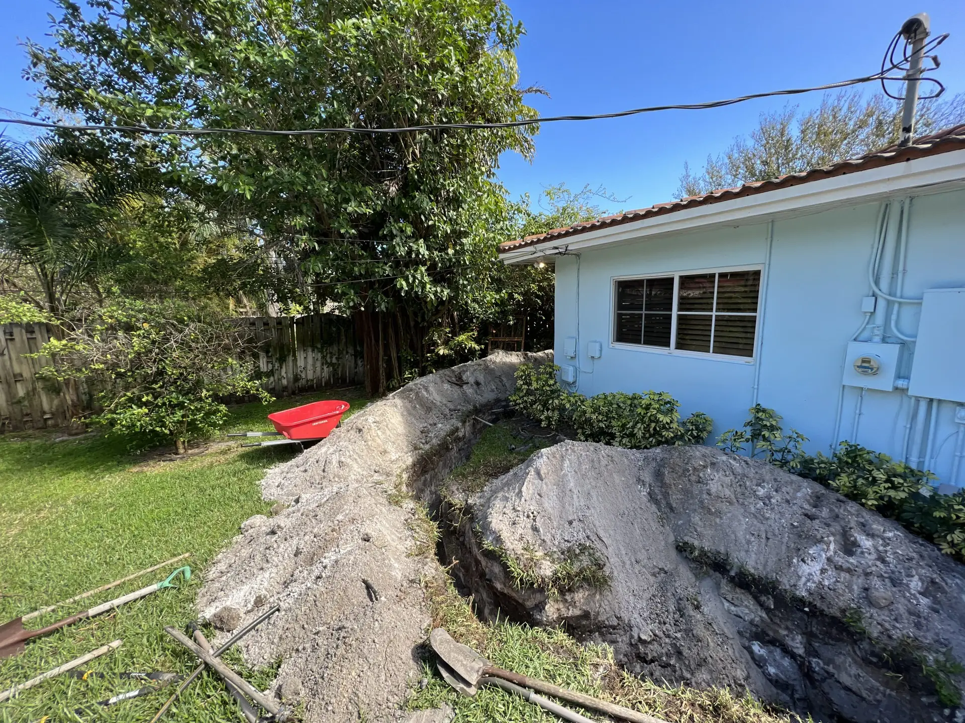 Long trench dug to replace failed cast iron sewer line with PVC