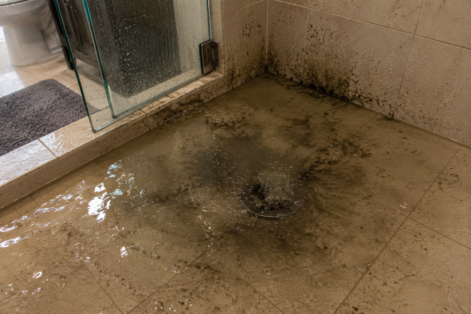 Overflowing shower drain emergency in older Pompano Beach bathroom